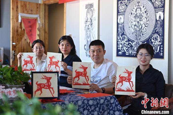 6月6日，在甘肅敦煌青年夜校課程中，青年學(xué)員展示學(xué)習(xí)敦煌非遺剪紙的成果。李亞龍 攝　　
